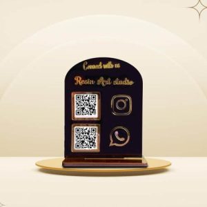 Gold mirror qr code stand on a jewelry counter displaying GPay and Instagram codes.
