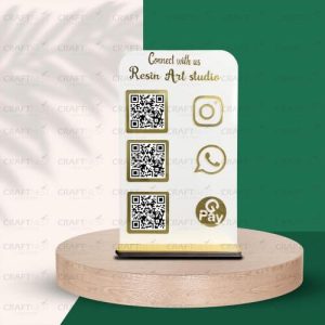 Close up of a rose gold acrylic stand with an Instagram logo and qr code asking clients to follow.