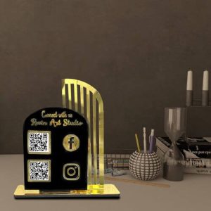 A dark acrylic paytm qr code stand placed next to a payment terminal.