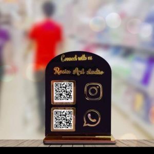 Customer scanning a gold qr code scanner stand with a smartphone.