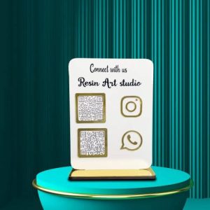 A customer scanning a WhatsApp QR code on a white acrylic stand at a reception counter.