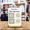 White acrylic desk display stand with Instagram and Google Pay QR codes on a white office desk.